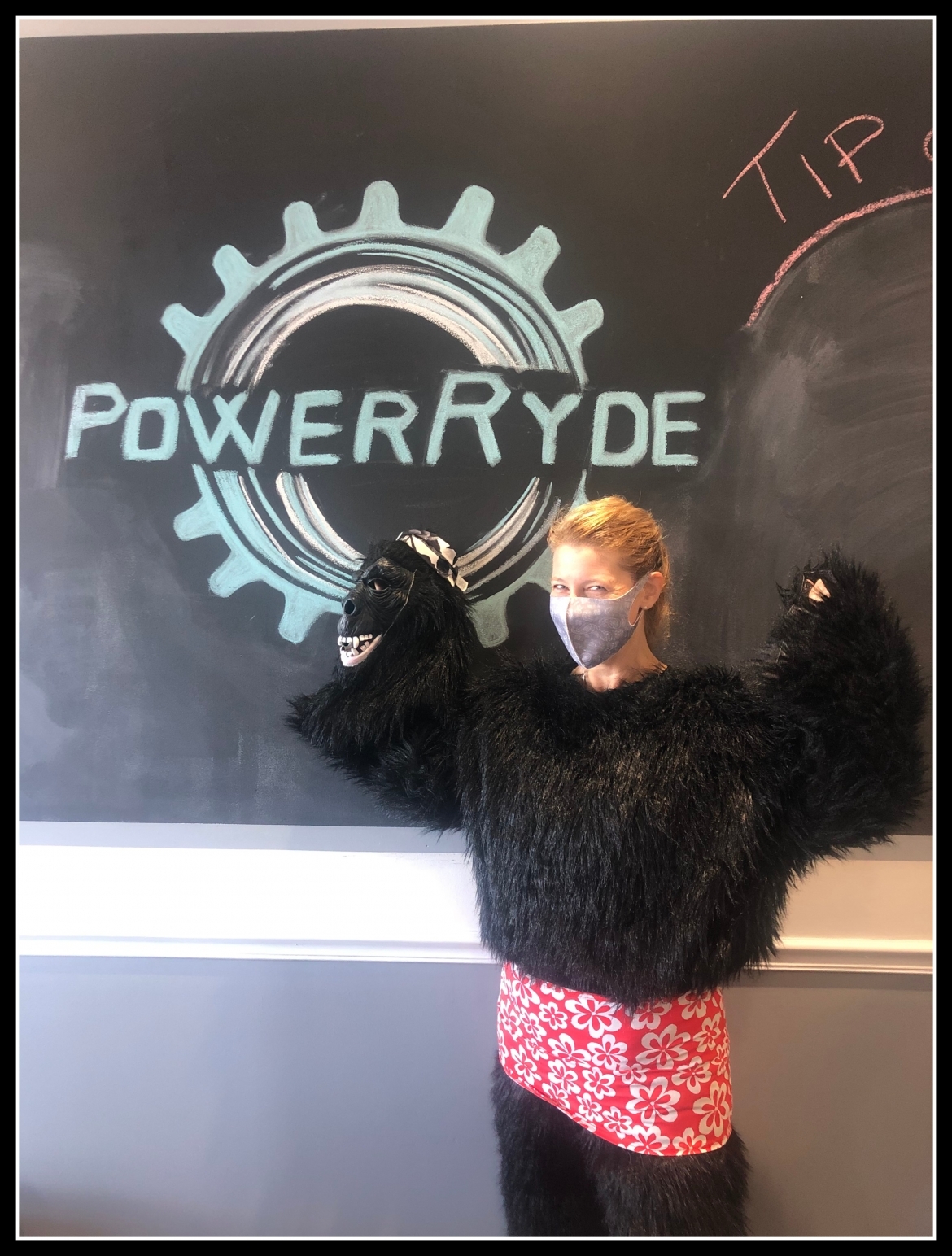 Tammy Brown with gorilla costume in front of chalk PowerRyde logo